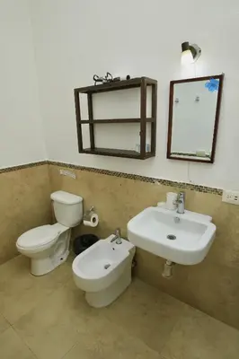 a bathroom with a toilet and a sink and a mirror at Brisa de Alma Guesthouse in Bayahibe