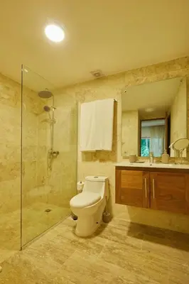 a bathroom with a toilet and a shower and a sink at Escape Oasis in Playa Dorada Pool & Beach in Puerto Plata