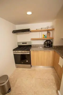 a kitchen with a stove and a counter top at Modern 2BR Caribbean Apt -Pool & Beach Access in Puerto Plata