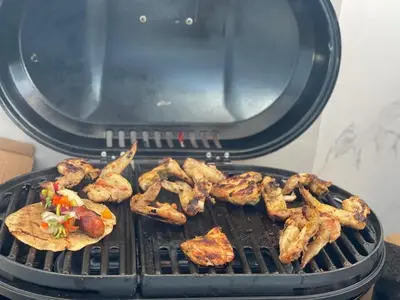 a grill with a bunch of food on it at Beach Days & City Nights! Centrally Near Everything in Santo Domingo