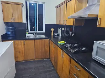 a kitchen with wooden cabinets and a stove top oven at Dreamvillage in Boca Chica
