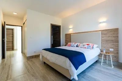a bedroom with a large bed and a table at La Stuga del Mar - Walk to Portillo Beach, Terrenas in Las Terrenas
