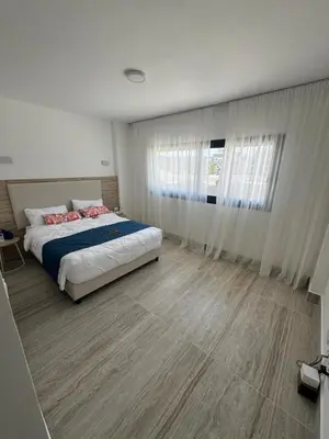 a bedroom with a bed and a large window at La Stuga del Mar - Walk to Portillo Beach, Terrenas in Las Terrenas