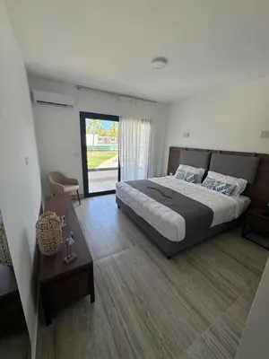 a bedroom with a large bed and a table at La Stuga del Mar - Walk to Portillo Beach, Terrenas in Las Terrenas