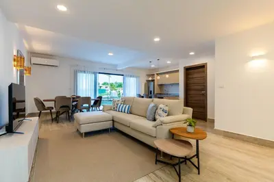 a living room with a couch and a table at La Stuga del Mar - Walk to Portillo Beach, Terrenas in Las Terrenas