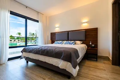 a bedroom with a large bed and a large window at La Stuga del Mar - Walk to Portillo Beach, Terrenas in Las Terrenas