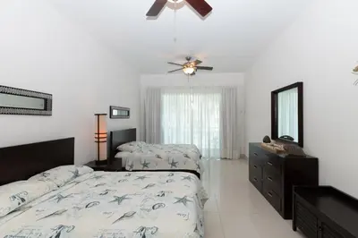 a bedroom with two beds and a ceiling fan at 1BR Ocean View Luxury Beachfront in Cabarete in Cabarete