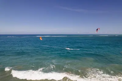 two people are kite surfing in the ocean at 1BR Ocean View Luxury Beachfront in Cabarete in Cabarete