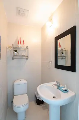 a bathroom with a sink and a toilet and a mirror at 1BR Ocean View Luxury Beachfront in Cabarete in Cabarete