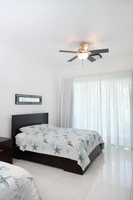 a bedroom with a bed and a ceiling fan at 1BR Ocean View Luxury Beachfront in Cabarete in Cabarete