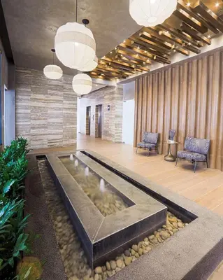 a lobby with a pond in the middle of a room at Upscale City Center Condo in Santo Domingo