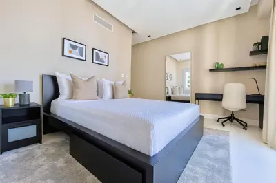 a bedroom with a bed and a desk and a chair at Upscale City Center Condo in Santo Domingo