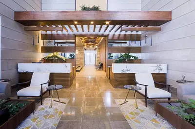 a lobby with chairs and a bar in a building at Upscale City Center Condo in Santo Domingo