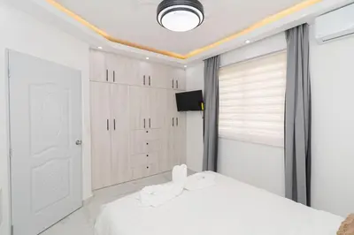 a bedroom with a white bed and a window at Cozy 1BR 1BA Bayahibe Getaway with Pool - Maravilla in San Rafael del Yuma