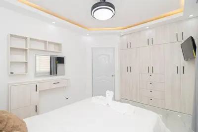 a white room with a bed and a tv at Cozy 1BR 1BA Bayahibe Getaway with Pool - Maravilla in San Rafael del Yuma