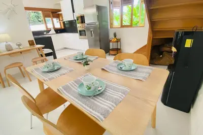 a dining room table with four chairs and a kitchen at Bonita Beach Villa in Las Terrenas