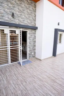 a garage with doors and a brick wall at Amazing 2BR apartment near the airport in Los Frailes