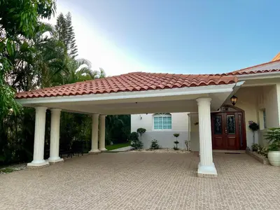 a white house with a large pavilion in front of it at Villa in Metro Country Club, Juan Dolio in Juan Dolio
