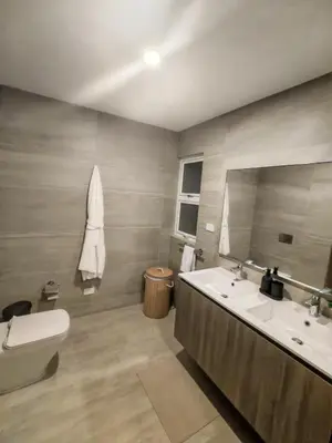 a bathroom with a sink and a toilet and a mirror at Apartamento de Lujo Punta Cana Hard Rock in Punta Cana