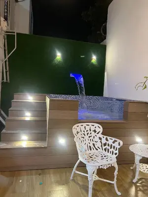a water fountain with two chairs and a waterfall at Casa Bonita con Jacuzzi in Los Mameyes