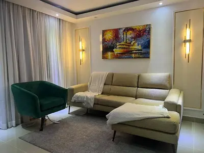 a living room with a couch and a chair at Casa Bonita con Jacuzzi in Los Mameyes