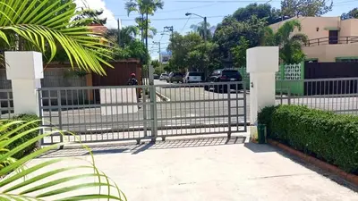 a gate in front of a fence with a street at Casa Bonita con Jacuzzi in Los Mameyes