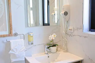a bathroom with a sink with a hair dryer on it at Elegant Cocotal 2BD Condo in Punta Cana