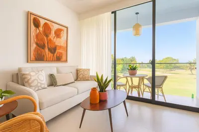 a living room with a couch and a table at Elegant Cocotal 2BD Condo in Punta Cana