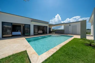 a swimming pool in the backyard of a house at Brand New Modern Caribbean Retreat 3BR in Sosúa