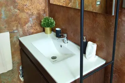 a bathroom with a white sink and a plant at Villa Modena in Las Terrenas