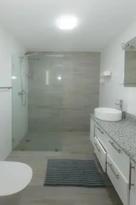 a bathroom with a shower and a sink and a toilet at Luxury Villa with Private Pool in Punta Cana in Punta Cana
