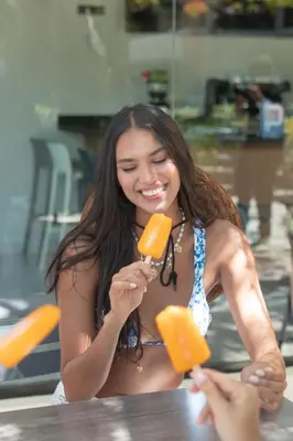 a woman is holding up a piece of cheese at Luxury Villa with Private Pool in Punta Cana in Punta Cana