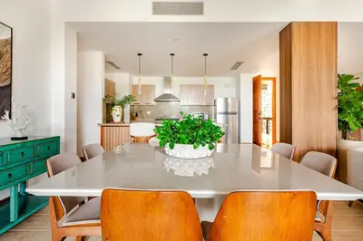 a kitchen and dining room with a white table and chairs at Casa Cielo 3 BR Penthouse with Views in La Romana