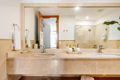 a bathroom with two sinks and a large mirror at Casa Cielo 3 BR Penthouse with Views in La Romana