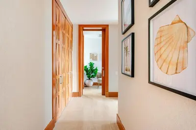 a hallway with a surfboard hanging on the wall at Casa Cielo 3 BR Penthouse with Views in La Romana