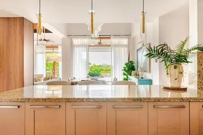 a kitchen with a island with a potted plant at Casa Cielo 3 BR Penthouse with Views in La Romana
