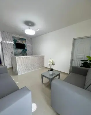 a living room with two couches and a table at Remanso de Paz in Pedernales