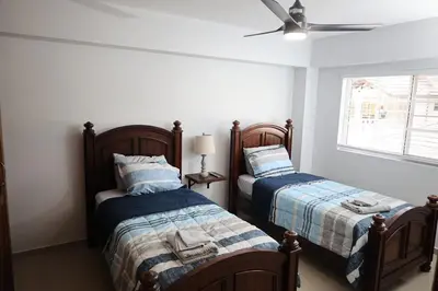 a bedroom with two beds and a ceiling fan at Emerald Vue - Private river entrance in Jarabacoa