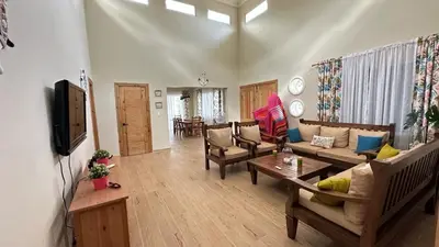 a living room with a couch and a tv in it at Villa Enma RD in Nizao