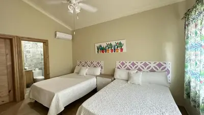 a bedroom with two beds and a window at Villa Enma RD in Nizao