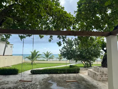 a swing in a yard with a view of the ocean at Villa Enma RD in Nizao