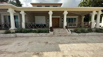 a house with a front porch and columns at Villa Enma RD in Nizao