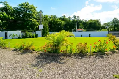 a garden with flowers in the middle of a yard at Penthouse with Large Rooftop Terrace & Parking in Sosúa