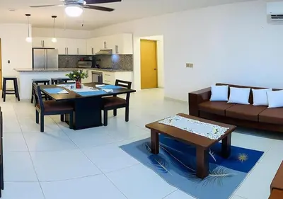 a living room with a couch and a table at Penthouse with Large Rooftop Terrace & Parking in Sosúa