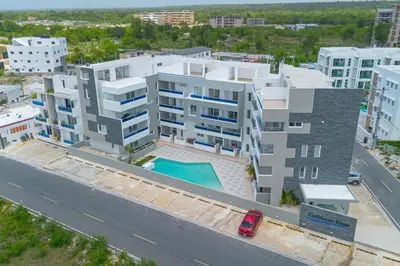 an aerial view of a building with a swimming pool at Modern 2BR Condo with Pool 10min walk to Beach - Caribbean Rose in San Rafael del Yuma