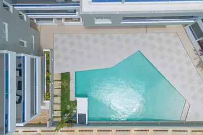 a large pool of water in the middle of a building at Modern 2BR Condo with Pool 10min walk to Beach - Caribbean Rose in San Rafael del Yuma