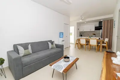a living room with a couch and a table at Modern 2BR Condo with Pool 10min walk to Beach - Caribbean Rose in San Rafael del Yuma