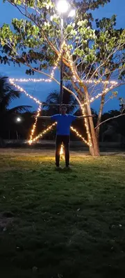 a man standing under a pole with lights at Villa Rancho losindios