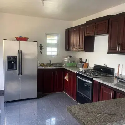 a kitchen with a white refrigerator and wooden cabinets at Villa Rancho losindios