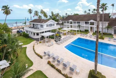 an aerial view of a house with a swimming pool and the ocean at Luxury Penthouse in front of the Sea in Las Terrenas in Las Terrenas